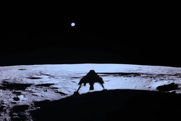 The Blue Ghost 1 lander silhouetted against the lunar surface after touching down on the Moon, with Earth visible in the dark sky above.